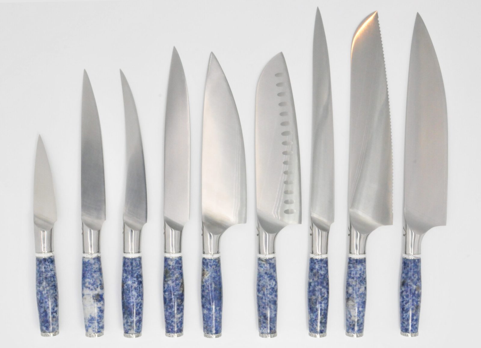 https://www.craftstoneknives.com/wp-content/uploads/2019/09/9-Knife-Set-with-a-Blue-Dot-Marble-Handle-White-Cubic-Zirconia-Stone-at-the-Back-of-the-Knife-and-White-Howlite-and-Stainless-Steel-Rings.jpg