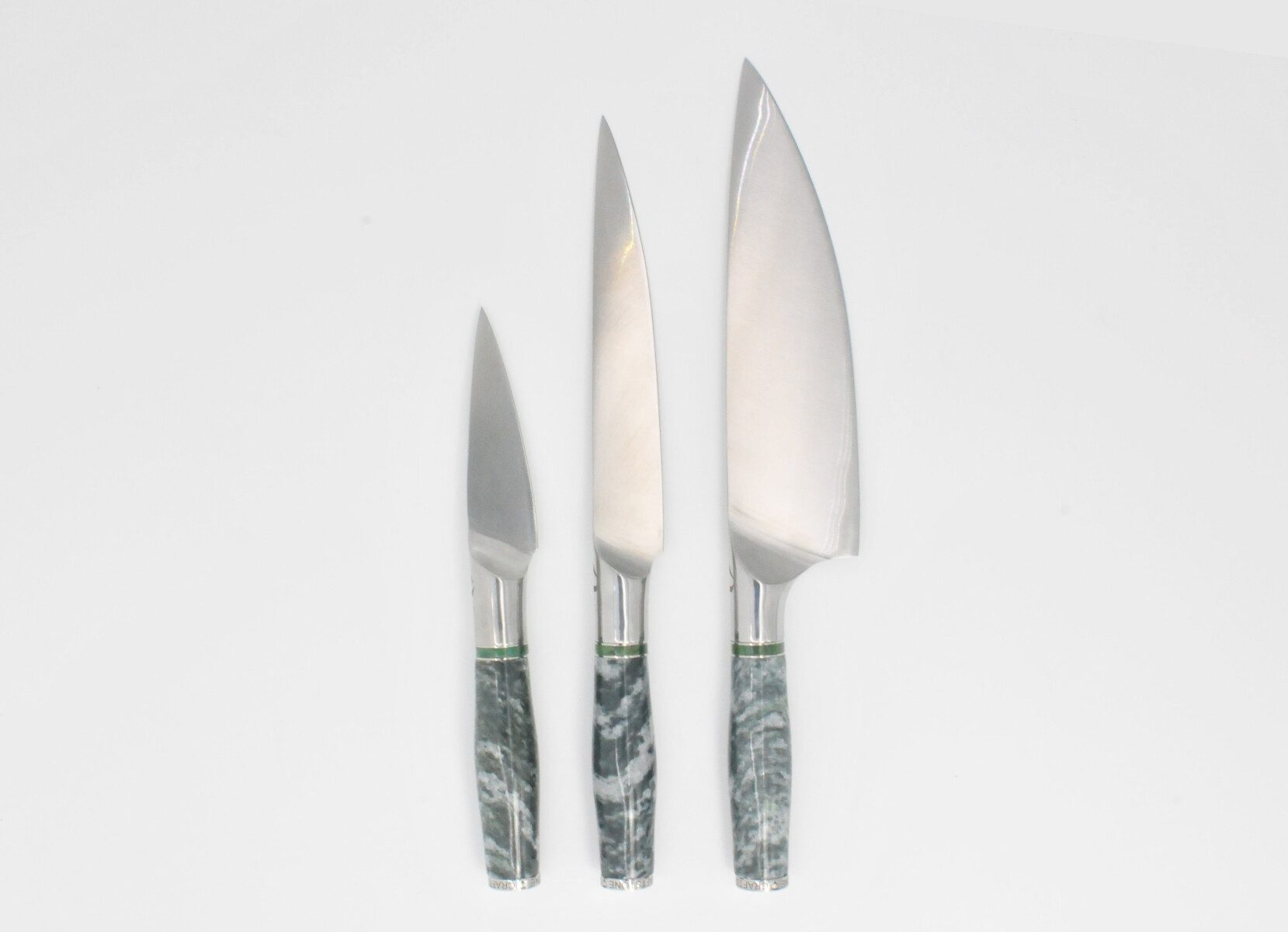 https://www.craftstoneknives.com/wp-content/uploads/bfi_thumb/3-Knife-Set-with-a-Mossy-Green-Marble-Handle-a-Cubic-Zirconia-Peridot-Color-Stone-at-the-Back-of-the-Knife-and-Green-Jade-and-Stainless-Steel-Decorative-Rings-3jbc82noutg3img7ftmya2.jpg